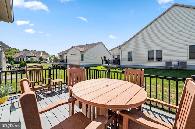 wooden terrace featuring a yard and central AC