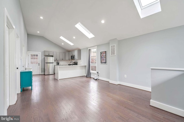 unfurnished living room featuring lofted ceiling and dark hardwood / wood-style floors