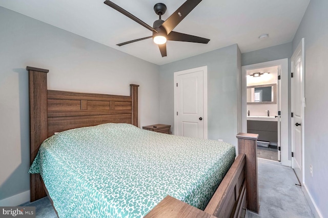 carpeted bedroom featuring ensuite bathroom and ceiling fan