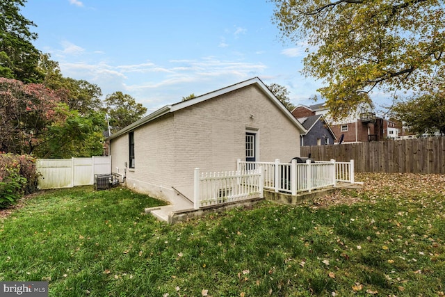 view of side of home featuring a lawn