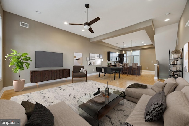 living room with recessed lighting, visible vents, and light wood-style floors