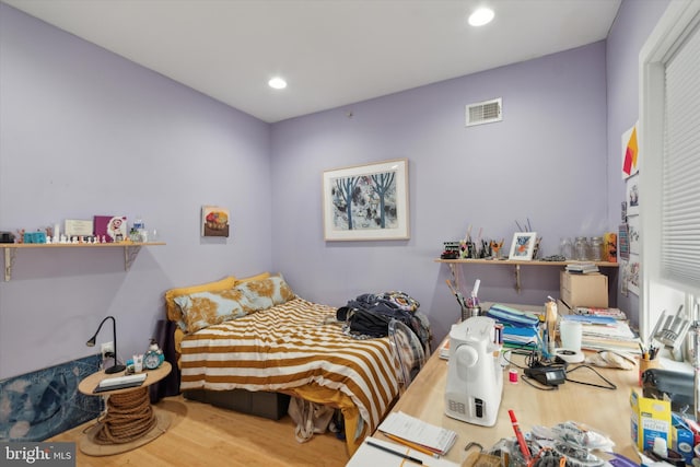 bedroom with hardwood / wood-style flooring