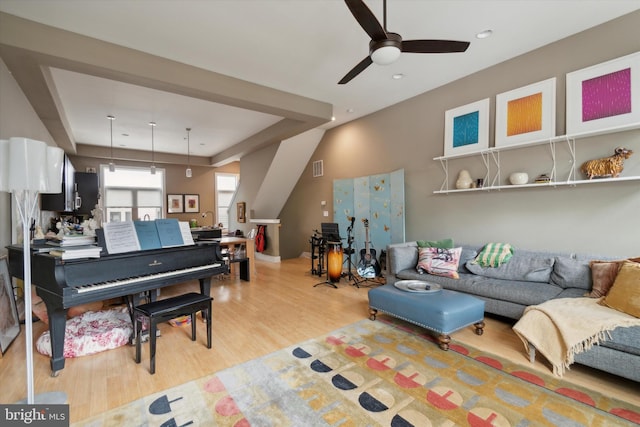 living room featuring ceiling fan and light hardwood / wood-style flooring