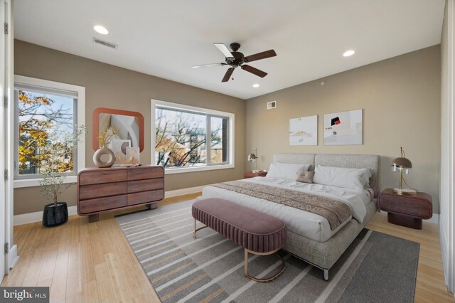 living room featuring light hardwood / wood-style flooring and ceiling fan