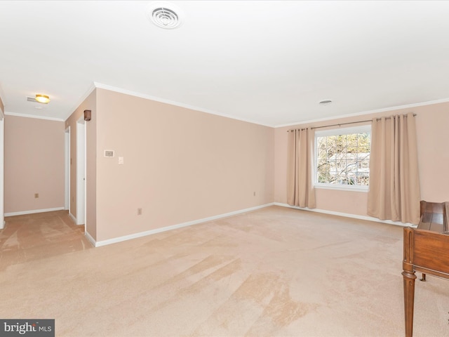 spare room featuring ornamental molding and light carpet