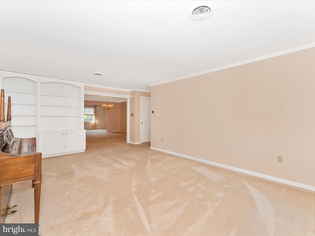 carpeted spare room featuring an inviting chandelier and crown molding