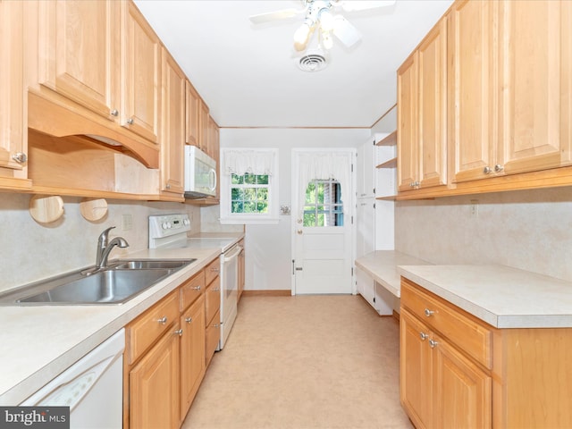 kitchen featuring white appliances, sink, and ceiling fan