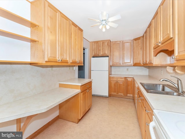 kitchen featuring sink, ceiling fan, and white fridge