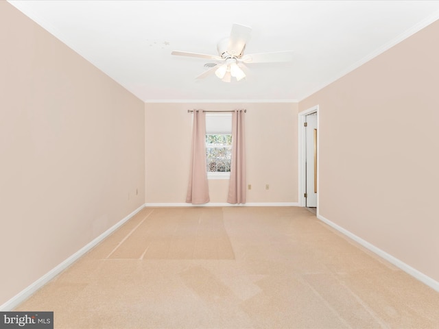 carpeted spare room with ceiling fan and ornamental molding