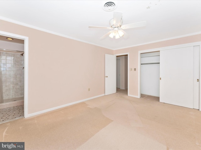 unfurnished bedroom with light colored carpet, ornamental molding, ensuite bathroom, and ceiling fan