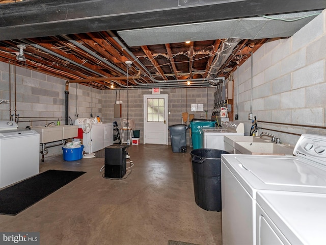 clothes washing area with sink and washing machine and dryer