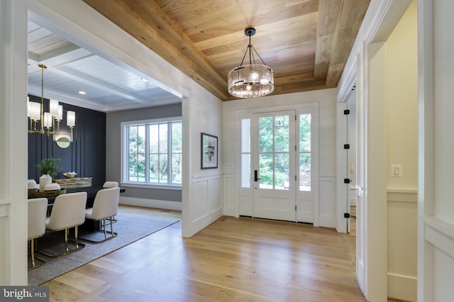 entryway featuring beamed ceiling, light hardwood / wood-style floors, a notable chandelier, and wooden ceiling