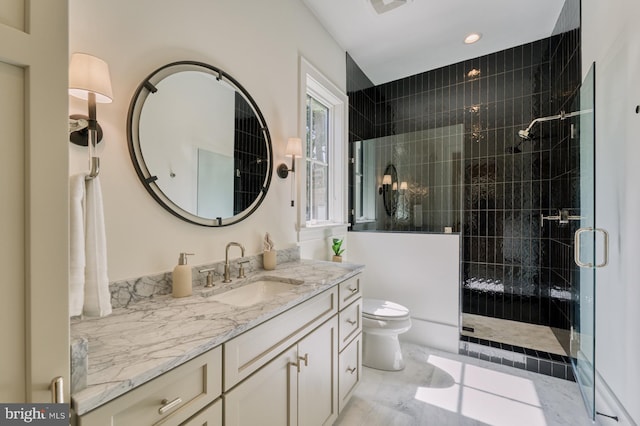 bathroom featuring vanity, toilet, an enclosed shower, and tile patterned flooring