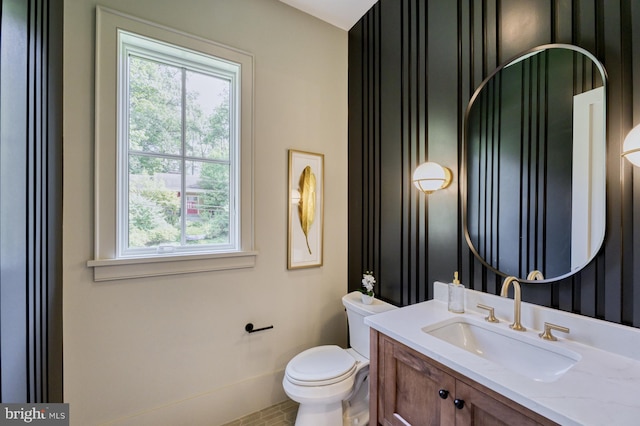 bathroom featuring toilet, plenty of natural light, and vanity