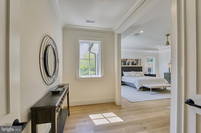 bedroom featuring crown molding and light hardwood / wood-style floors