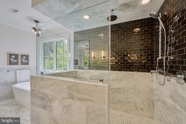 bathroom with tile walls and independent shower and bath