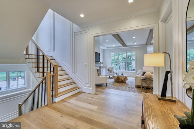 interior space featuring light hardwood / wood-style flooring and beam ceiling