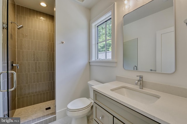 bathroom featuring vanity, toilet, and an enclosed shower