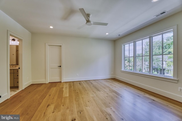 spare room with ceiling fan, light hardwood / wood-style floors, and sink