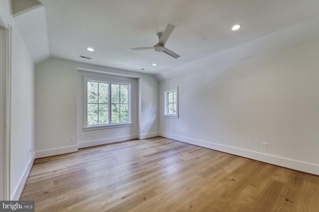 unfurnished room featuring vaulted ceiling, ceiling fan, and light hardwood / wood-style floors