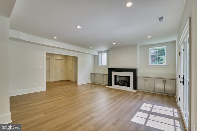 unfurnished living room featuring light wood-type flooring