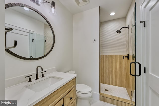 bathroom with vanity, toilet, and walk in shower