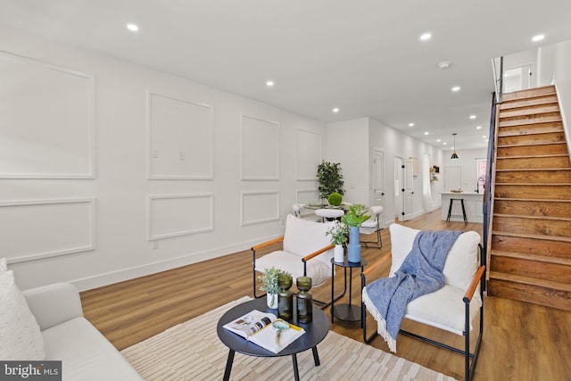 sitting room with wood-type flooring