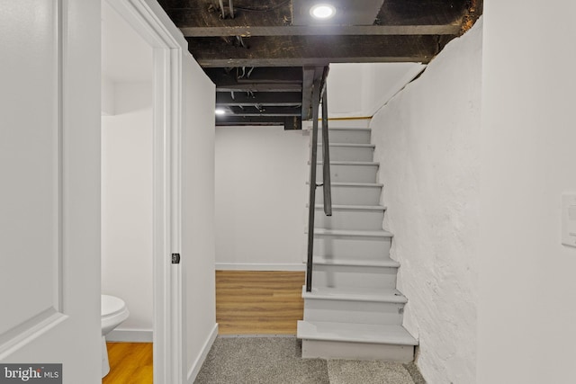 staircase with hardwood / wood-style flooring