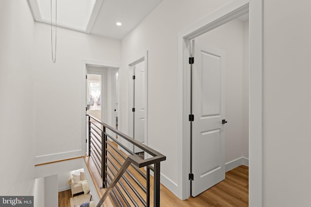 corridor with light hardwood / wood-style flooring