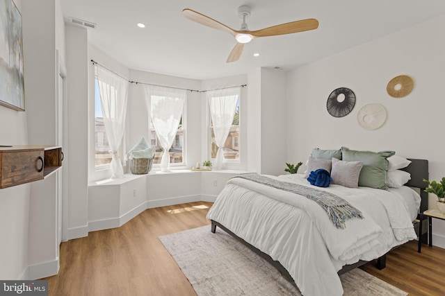 bedroom with light hardwood / wood-style flooring and ceiling fan