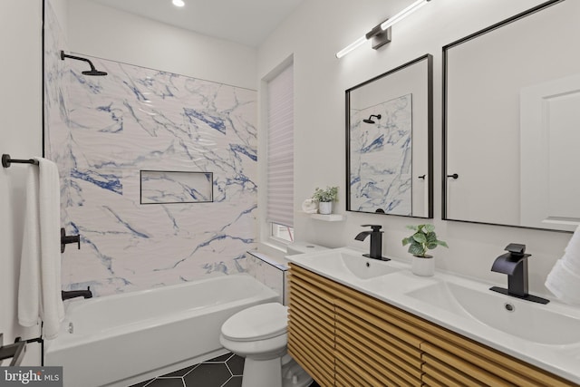 full bathroom featuring tile patterned flooring, tiled shower / bath, toilet, and vanity