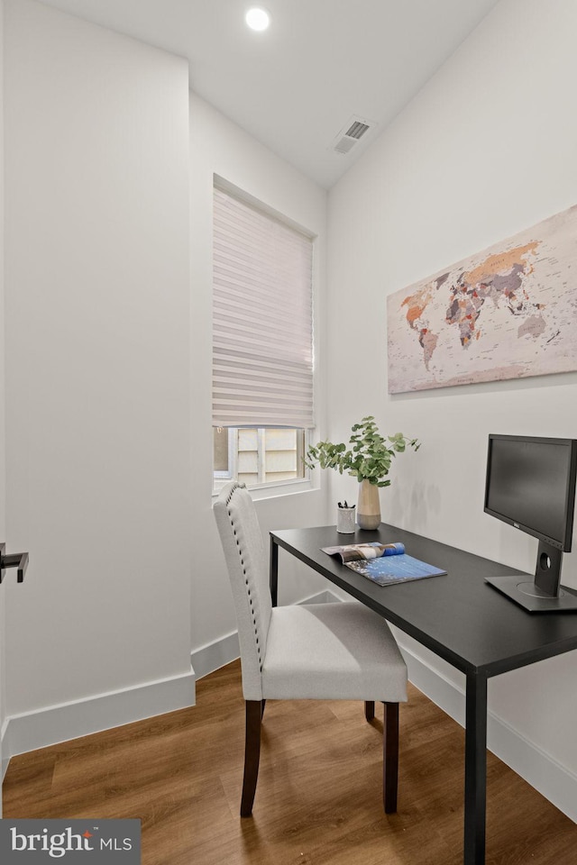 home office with hardwood / wood-style floors