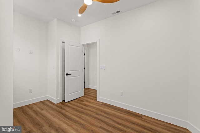 unfurnished room featuring ceiling fan and wood-type flooring