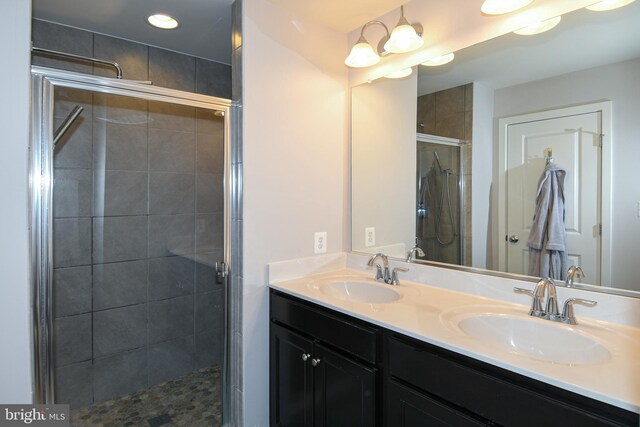 bathroom with vanity and a shower with shower door