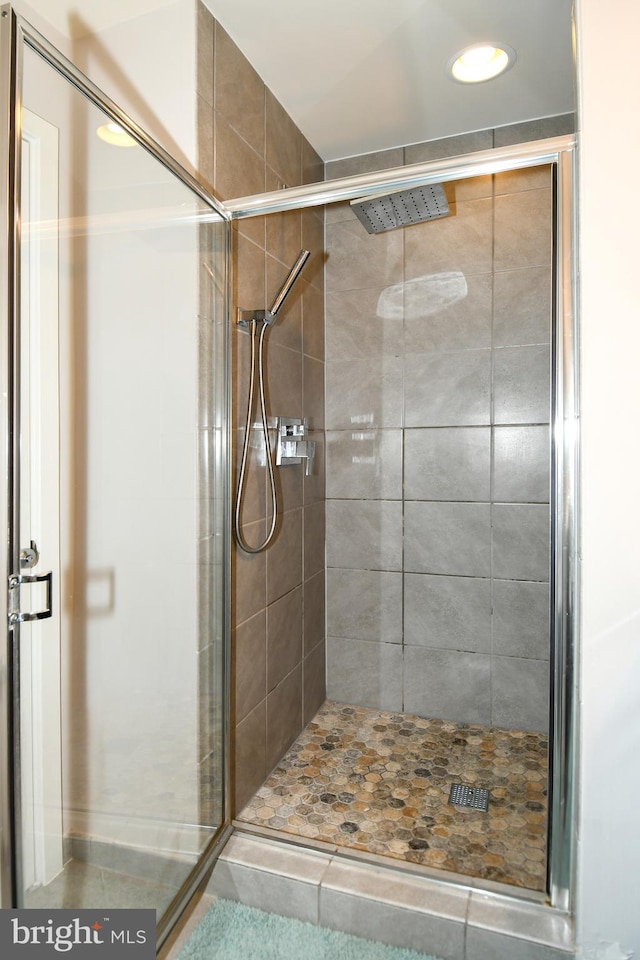 bathroom featuring tile patterned floors and an enclosed shower