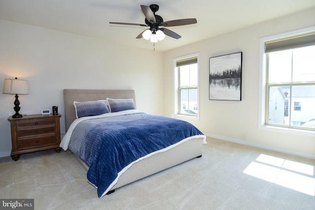 bedroom with light carpet and ceiling fan