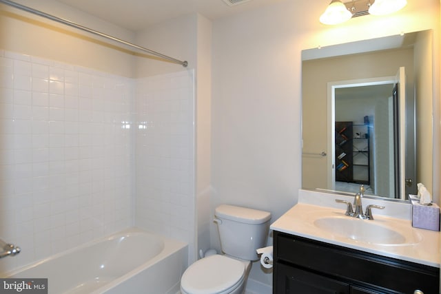 full bathroom with vanity, tiled shower / bath combo, and toilet