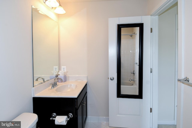 full bathroom featuring vanity, tile patterned floors, tiled shower / bath combo, and toilet