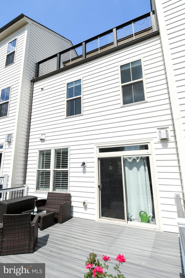 back of property with outdoor lounge area and a deck