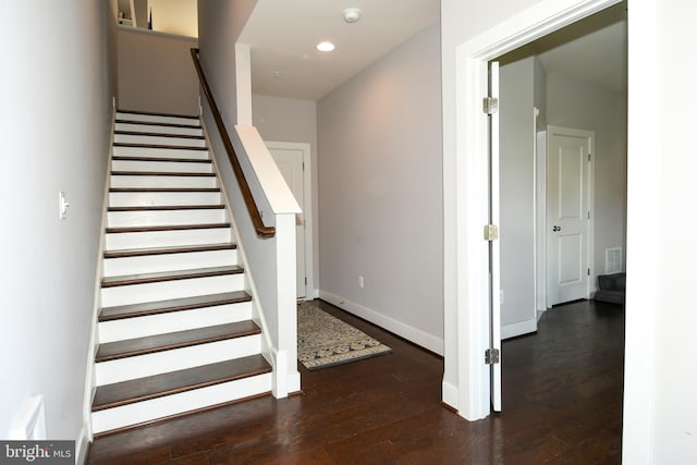 stairs with hardwood / wood-style flooring