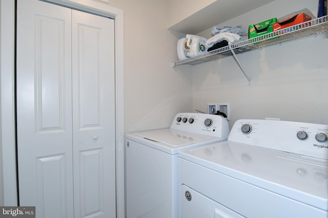 clothes washing area featuring washer and clothes dryer