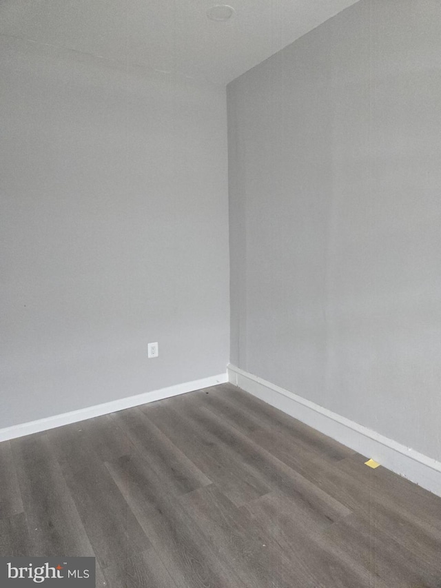 4111 N 8th St, Philadelphia, PA 19140 - spare room with baseboards and dark wood-style floors