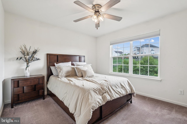 bedroom featuring light colored carpet and ceiling fan