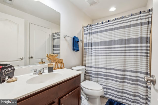 bathroom with vanity, toilet, curtained shower, and tile patterned flooring