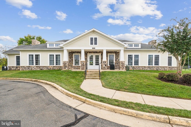 view of front of property with french doors and a front yard