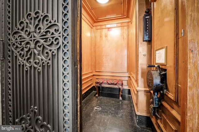 interior space with crown molding and a decorative wall