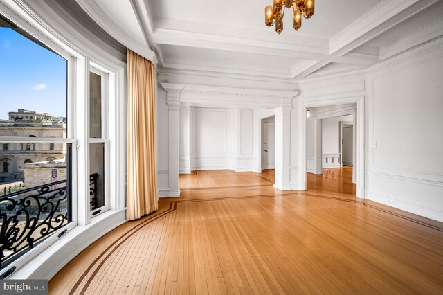 hallway featuring crown molding, light wood-type flooring, a notable chandelier, coffered ceiling, and beam ceiling