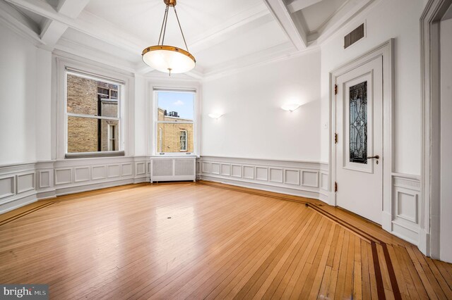 interior space featuring crown molding, radiator, and light wood-type flooring