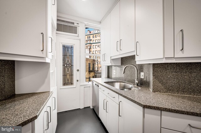 kitchen featuring white cabinets, a wall mounted air conditioner, sink, tasteful backsplash, and stainless steel dishwasher