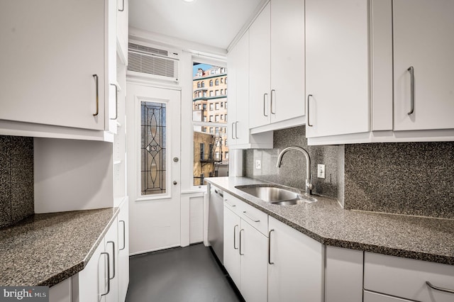 kitchen featuring a sink, backsplash, white cabinets, a wall mounted AC, and stainless steel dishwasher